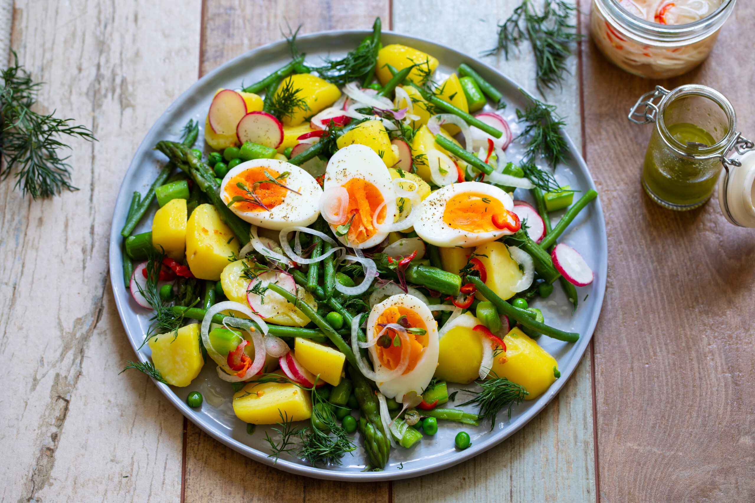 Summer salad with potatoes, green beans, asparagus, peas and radishes